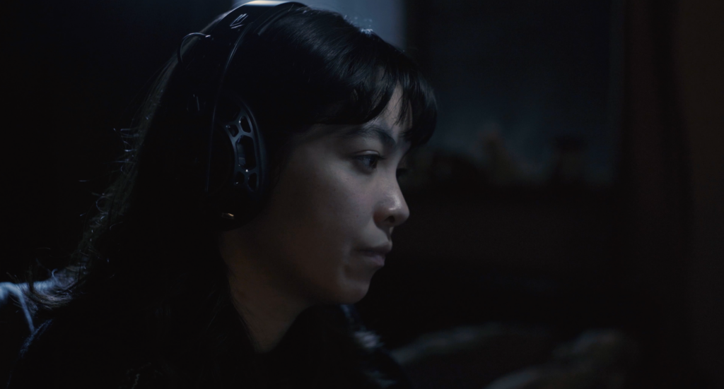 Person with headphones looks right.